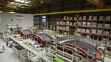Steel cages being loaded in the carousel