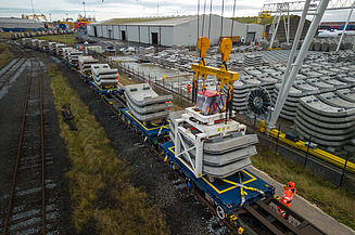 Concrete tunnel segments being loaded onto a train