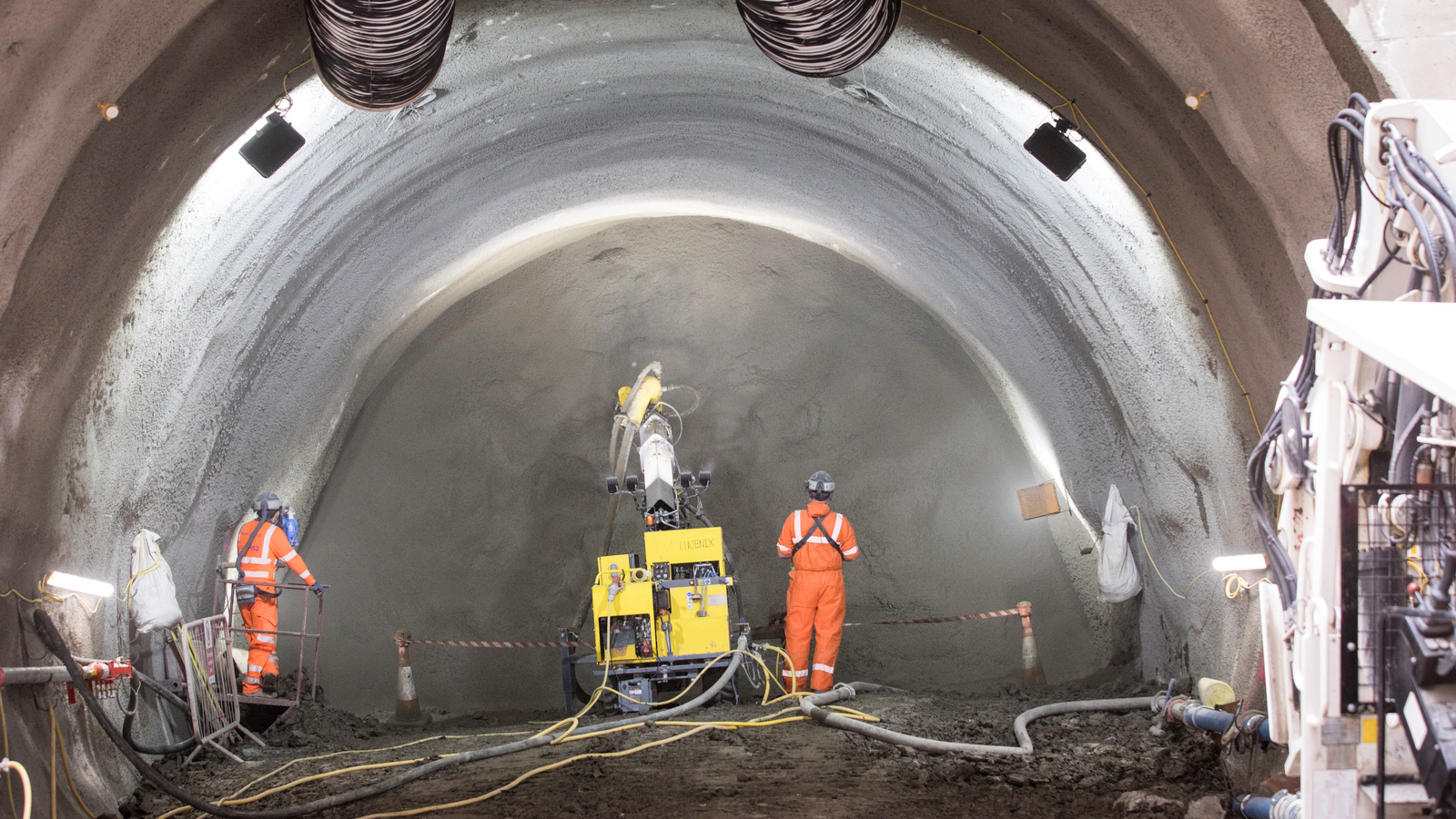 The process of a tunnel being constructed using spray concrete lining