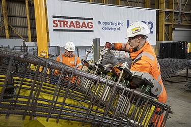 Man constructing the steel frame component of a segment