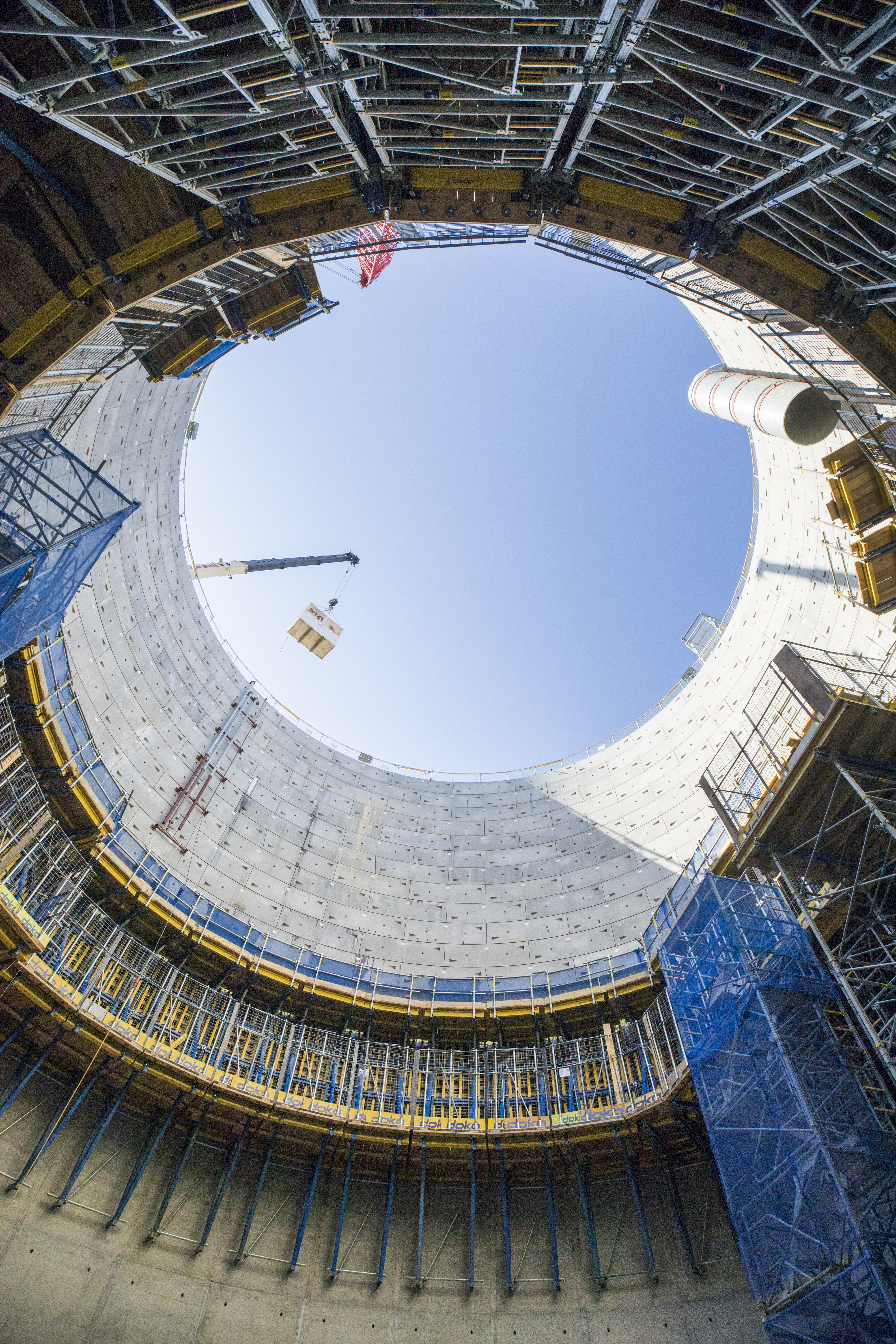View from the bottom of a shaft looking up at the sky