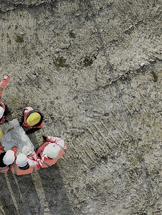 People on a constructions site standing in a circle