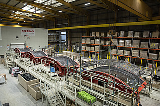 Steel cages being loaded in the carousel