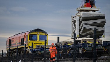 Tunnel segments being loaded onto a train to be transported to London