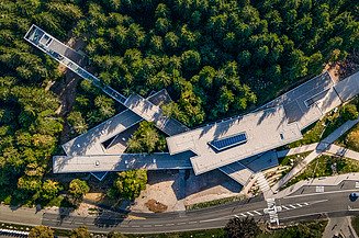 Bird's eye view of a wooden building in the forest