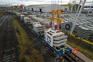 Concrete tunnel segments being loaded onto a train
